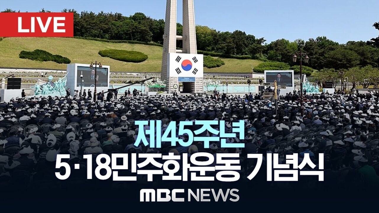 많은 사람들이 모인 가운데 국립 5·18 민주묘지 앞에서 열린 제45주년 5·18민주화운동 기념식 현장, 중앙에는 태극기와 추모탑이 보이고 'LIVE' 및 'MBC NEWS'라는 문구가 있음.